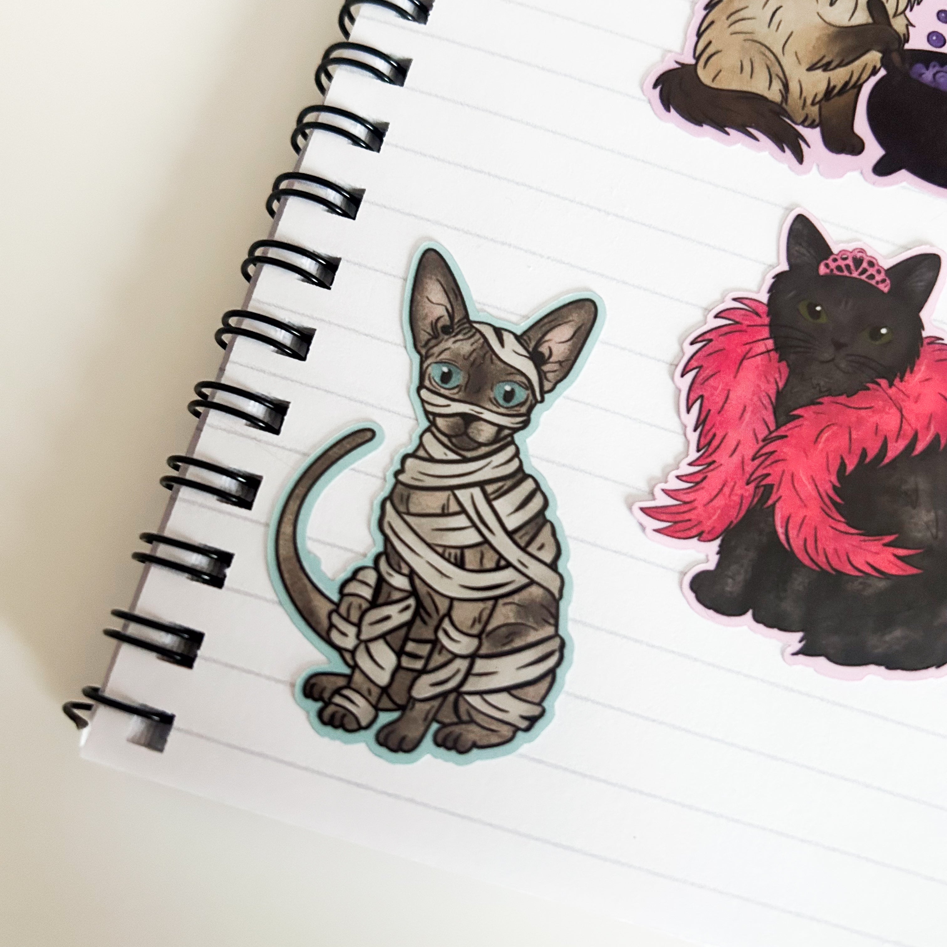 Grey Sphynx Cat Sticker in a mummy costume on paper