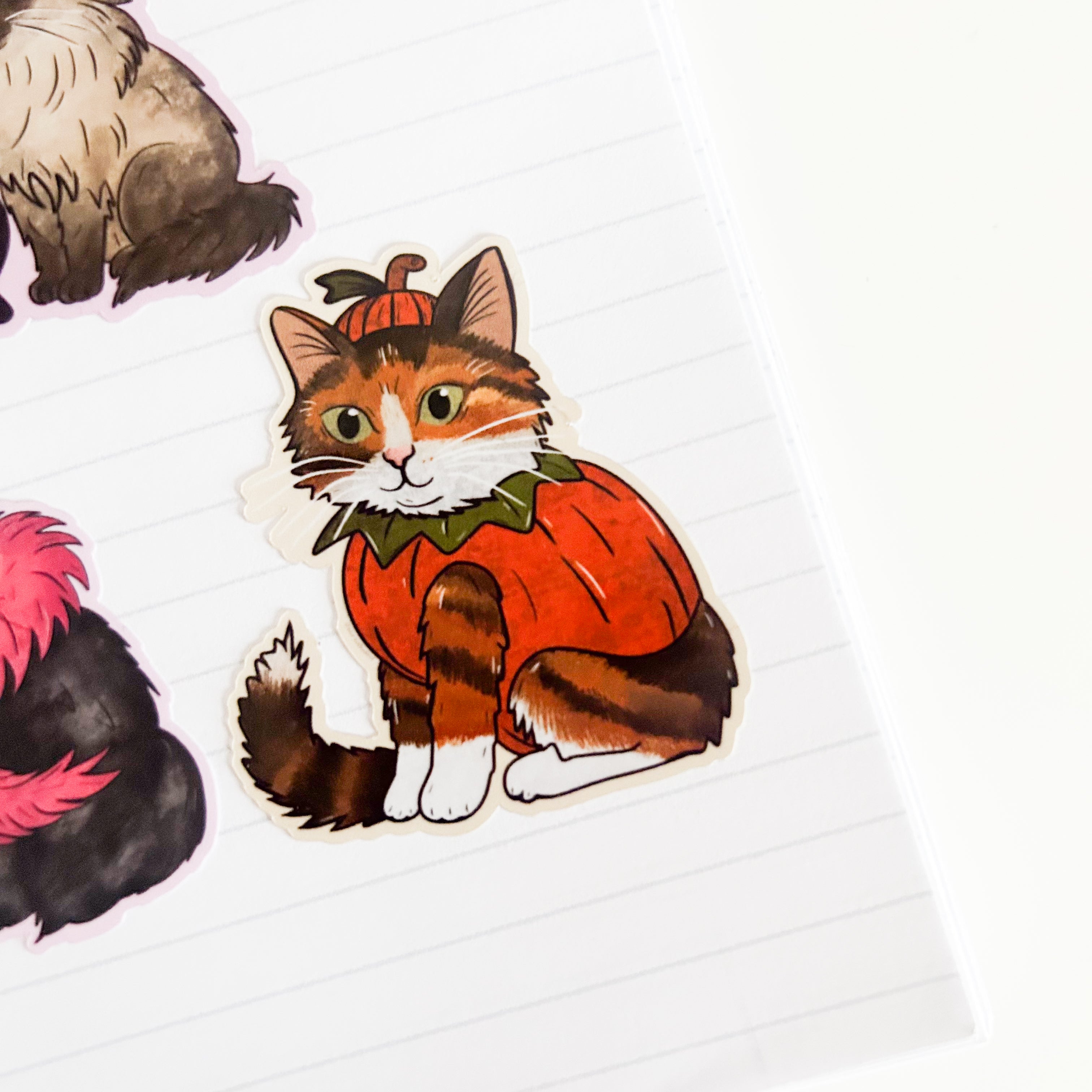 Ginger Cat in a pumpkin costume sticker on a white background