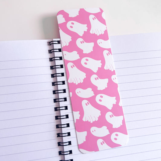 Pink bookmark with ghost pattern on a notebook page